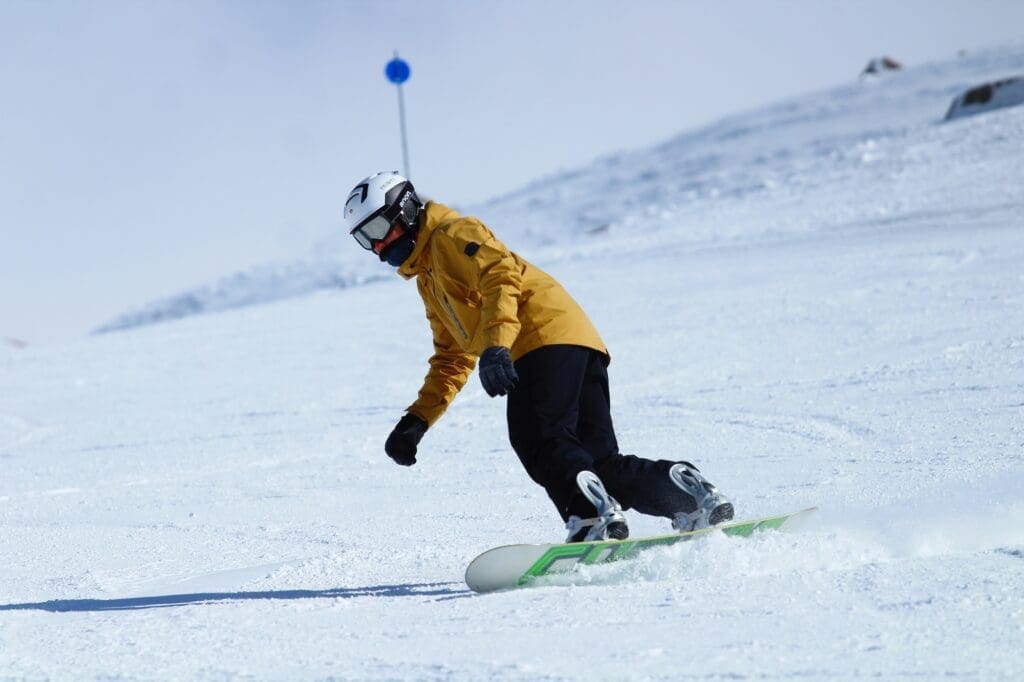 a snowboarder gliding on gentle terrain