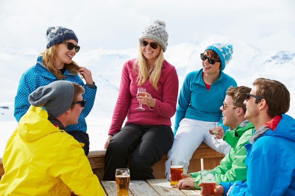 Group Of Friends Enjoying Drink In Bar At Ski Resort